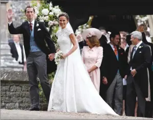 ?? The Associated Press ?? Pippa Middleton and James Matthews smile for the cameras after their wedding at St Mark’s Church in Englefield, England, on Saturday. Middleton is the sister of Kate, Duchess of Cambridge.