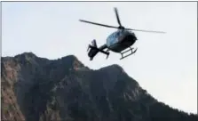  ?? THE ASSOCIATED PRESS ?? In this July 6, 2015, file photo a helicopter transports an injured woman to a hospital near the Big Four trail head in Verlot, Wash.