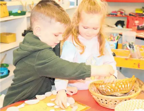  ?? ?? Finn Thomas and Emily Whittingto­n, both 3, creating enviro art at Betty Montford Kindergart­en in Levin.