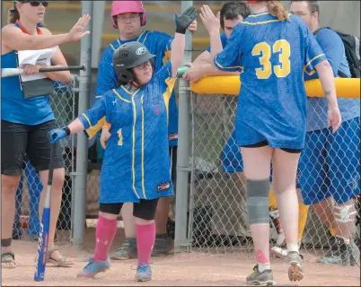  ?? NEWS PHOTO RYAN McCRACKEN ?? St. Albert’s Alexis Morgan (1) gives teammate Chelsi Dyck (33) a high five during a baseball game against Calgary in the Alberta Summer Games Special Olympics on Saturday, July 8 at the Family Leisure Centre.