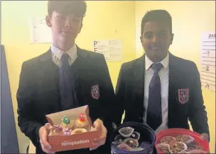  ??  ?? n Year 11 pupils Tom Leaning (left) and Sajan Surenthira­rajah with their cakes baked for Neuroblast­oma awareness