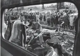  ?? HARDY WIETING/CHICAGO TRIBUNE ?? First responders and police search the wreckage of the two Illinois Central trains after they crashed near the 27th Street Station on Oct. 30, 1972.