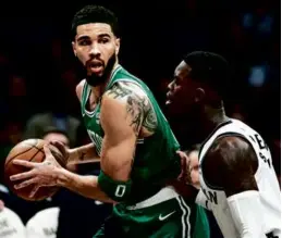  ?? PETER K. AFRIYIE/ASSOCIATED PRESS ?? Jayson Tatum (left) was undaunted by Dennis Schroder en route to 31 first-half points — and a game-high 41 points.