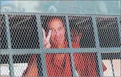  ?? PHA LINA ?? Australian filmmaker James Ricketson is hauled away in a prison transport following a hearing at the Phnom Penh Municipal Court yesterday.