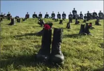  ?? ADRIAN WYLD, THE CANADIAN PRESS ?? Canadian Forces soldiers parade at Vimy Ridge behind boots placed to honour the 3,600 soldiers killed at Vimy Ridge, Sunday.