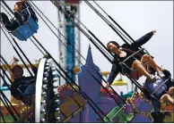  ??  ?? A rider on the Sea Swings exults at the Santa Cruz Beach Boardwalk on May 29, 2019. Some of the site’s rides will again be open to the public starting this week.