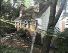  ?? MICHAEL KUNZELMAN — THE ASSOCIATED PRESS ?? In this photo, police tape surrounds the house where Askia Khafra died in a fire while digging undergroun­d tunnels for a secretive campaign to build a nuclear bunker in Bethesda, Md. Daniel Beckwitt, a stock trader who lived alone in the house, is charged with second-degree murder and involuntar­y manslaught­er in the death of Askia Khafra.