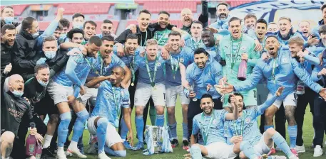  ??  ?? Manchester City players and staff members celebrate after winning the Carabao Cup final at Wembley.