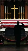  ?? AP/DAVID J. PHILLIP ?? A service member pays respects at the flag-draped casket of former President George H.W. Bush in St. Martin’s Episcopal Church in Houston, Texas, after it was flown from Washington on Air Force One following Wednesday’s funeral.