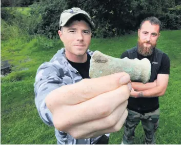  ??  ?? Ancient find
Tony Crews, left and Dean McCrindle with their Bronze Age axe head found on a farm