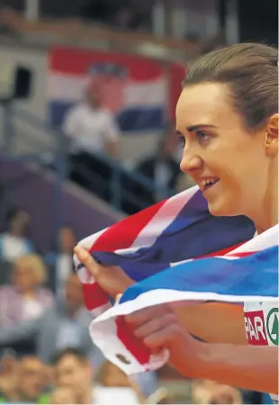  ??  ?? Laura Muir celebrates after winning the gold medal and breaking the British record in the 1500 metres final