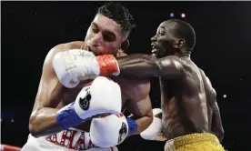  ??  ?? Terence Crawford, right, punches Amir Khan during the fifth round of their WBO world welterweig­ht championsh­ip boxing match. Photograph: Frank Franklin II/AP