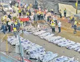  ?? AFP ?? Security officials and rescuers gather bodies of the victims who died in a stampede in Meron.