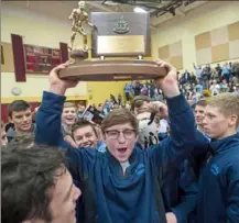  ?? Steph Chambers/Post-Gazette ?? Burrell's Austin Mele hoists the trophy after the Buccaneers won their 13th Class 2A team championsh­ip in a row. Mele was one of three Bucs to finish with four gold medals.