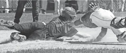  ?? MARK HOFFMAN / MILWAUKEE JOURNAL SENTINEL ?? Pewaukee's Jackson Servais is tagged out at home by Denmark catcher Rheis Johnson during the seventh inning of their Division 2 state semifinal Thursday in Appleton.