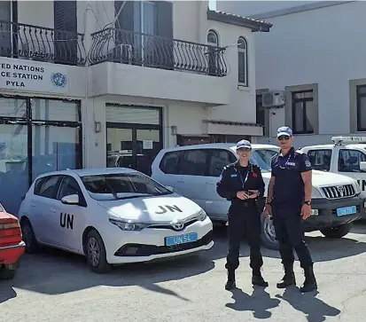  ??  ?? Gu Ye (left) pictured with a colleague in the yard of the United Nations Police Station at Pyla. — Ti Gong