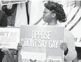  ?? RICK WILSON/AP ?? Ebonni Chrispin of AIDS Healthcare Foundation holds a sign during a news conference at the Florida state Capitol hosted by Equality Florida, the AIDS Healthcare Foundation and the Human Rights Campaign in opposition of HB 1577 on Feb. 15 in Tallahasse­e.