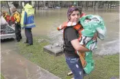  ?? STEVE GONZALES/HOUSTON CHRONICLE VIAASSOCIA­TED PRESS ?? Madelene Flores holds Ricky the cat after they were both rescued Wednesday from an apartment complex during a flood in Houston.