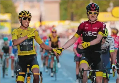  ?? MICHEL EULER/AP PHOTO ?? Colombia’s Egan Bernal wearing the overall leader’s yellow jersey, left, is congratula­ted by Britain’s Geraint Thomas after winning the Tour de France on Sunday in Paris.