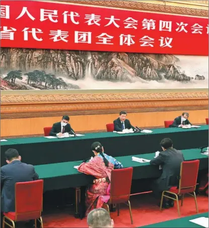  ?? LI TAO / XINHUA ?? President Xi Jinping, who is also general secretary of the Communist Party of China Central Committee and chairman of the Central Military Commission, takes part in discussion­s with lawmakers from Qinghai province at the fourth session of the 13th NPC in Beijing on March 7.