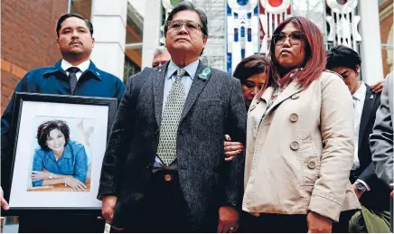  ?? Photo: GETTY IMAGES ?? Antonio Gotingco, centre, the husband of Blessie Gotingco, stands alongside family outside the High Court at Auckland yesterday, where the man accused of her murder was found guilty.