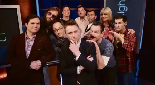  ?? GETTY IMAGES FOR COMEDY CENTRAL ?? The State reunited for an appearance on Comedy Central’s “@midnight” in 2014. From left: Michael Ian Black, Michael Jann, David Wain, Ken Marino, “@midnight” host Chris Hardwick, Michael Showalter, Joe Lo Truglio, Thomas Lennon, Kerri Kenney-Silver, and Robert Ben Garant.