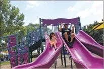  ?? URIEL J. GARCIA/THE NEW MEXICAN ?? Gerardo Armendariz hits the slides with his 4-year-old daughter, Izabella Armendariz, at Torreon Park on Saturday.