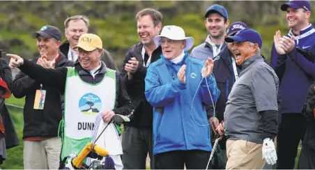  ?? Cliff Hawkins / Getty Images ?? Jimmy Dunne (wearing glove) gets a round of applause for a shot on the second hole during second-round play at Spyglass Hill.