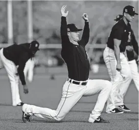  ?? [JUNFU HAN/DETROIT FREE PRESS] ?? Detroit Tigers pitcher Matt Manning stretches during spring training at TigerTown in Lakeland, Fla., on Saturday.