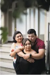  ??  ?? Above: Maria Fuentes with mother Aida Ruiz and father Santos Fuentes outside their home.