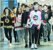  ?? GRAHAM HUGHES / THE CANADIAN PRESS ?? Students at John Rennie High School in Montreal wear jerseys Thursday in honour of the bus crash victims.