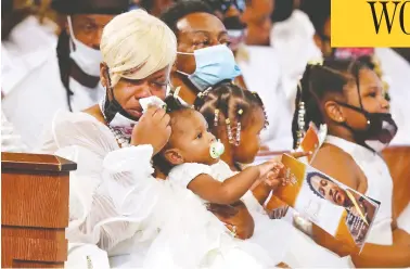  ?? CURTIS COMPTON / POOL / AFP VIA GETTY IMAGES ?? Tomika Miller, wife of Rayshard Brooks, holds their one-year-old daughter Dream during Brooks’ funeral in Ebenezer Baptist Church on Tuesday in Atlanta, Ga. Brooks was shot in the back by police nearly two weeks ago.