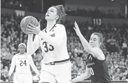  ??  ?? Notre Dame forward Kathryn Westbeld shoots past Oregon guard Sabrina Ionescu on Monday in Spokane, Wash. JAMES SNOOK/USA TODAY SPORTS