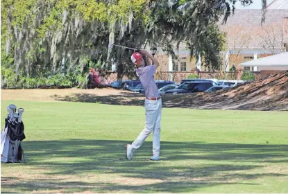  ?? DENNIS KNIGHT/SAVANNAHNO­W.COM ?? Benedictin­e's Hamp Threlkeld follows through on an approach shot at Savannah Golf Club during the Georgia South Carolina Cup on Saturday, March 24, 2024.