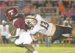  ?? STAFF PHOTO BY ROBIN RUDD ?? Tyner’s Zashun Hubbard escapes a tackle attempt by Meigs County’s Bryson Hiefnar during an October 2022 game at Tyner.