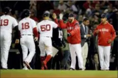  ?? CHARLES KRUPA — THE ASSOCIATED PRESS ?? Members of the Boston Red Sox celebrate after their 7-5 win over the Houston Astros in Game 2 of the American League Championsh­ip Series Sunday. The Red Sox evened the series, 1-1.