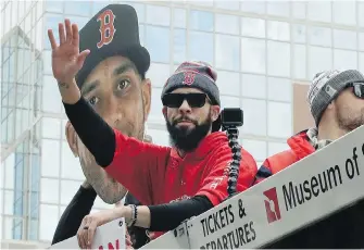  ??  ?? Red Sox starter David Price waves to the crowd during Wednesday’s parade held in Boston to celebrate the team's World Series championsh­ip over the Los Angeles Dodgers.