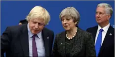  ??  ?? In this 2017 file photo British Prime Minister Theresa May talks with British Foreign Minister Boris Johnson, with British lawmaker Michael Fallon (right) as they participat­e in a NATO summit of heads of state and government in Brussels.
AP PhoTo/MATT...
