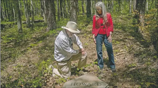  ?? (Columbus Ledger-Enquirer/Madeleine Cook) ?? Siblings Ralph and Jean Howard pause at their headstone in the Whispering Hills Memorial Nature Preserve in LaGrange, Ga.