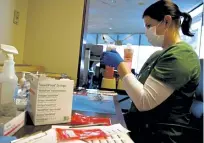  ?? Rachel Ellis, The Denver Post ?? Carol Elston prepares the Moderna vaccine for recipients coming in for their second dose at Presbyteri­an St. Luke's Medical Center in Denver on Jan. 15.