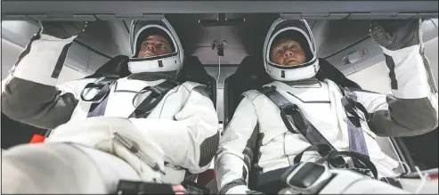  ??  ?? NASA astronauts Doug Hurley and Bob Behnken familiariz­e themselves with SpaceX’s Crew Dragon, the spacecraft that will transport them to the Internatio­nal Space Station as part of NASA’s Commercial Crew Program, at the Kennedy Space Center in Cape Canaveral, Fla., in 2018.