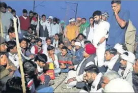  ?? HT PHOTO ?? Gujjar leader KS Bainsla along with supporters sit on the tracks at Malarna railway station to block route in Sawai Madhopur on Friday.