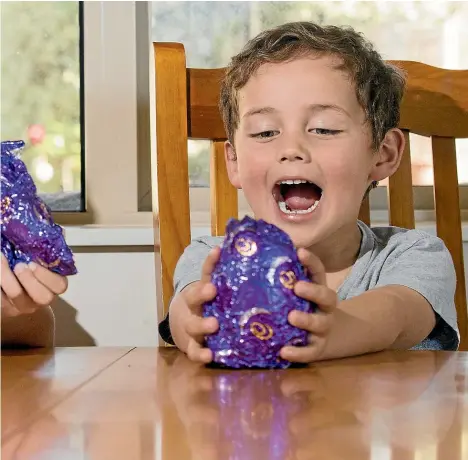  ??  ?? Eight-year-old Lachlan Ryan and Fletcher Ryan, 5, tuck into a hollow chocolate Easter egg each – one of the most over-packaged products available.