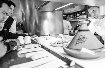  ??  ?? Olmos, an executive sous chef, works the line during dinner service at Boulud Sud in Manhattan. Olmos began as a dishwasher at Cafe Boulud in 2005. — WP-Bloomberg photos