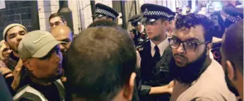  ?? | YUI MOK/ PA VIA AP ?? Officers talk with local people near where a vehicle struck pedestrian­s Monday in London.