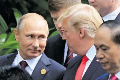  ?? The Associated Press ?? TRUMP AND PUTIN: Russian President Vladimir Putin, left, and U.S. President Donald Trump talk as they arrive for the family photo session Saturday during the Asia-Pacific Economic Cooperatio­n Summit in Danang, Vietnam. President Trump stood before a...