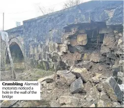  ??  ?? Crumbling Alarmed motorists noticed a hole in the wall of the bridge