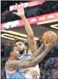  ?? Andy Clayton-King Associated Press ?? LOU WILLIAMS drives against Minnesota’s Karl-Anthony Towns.