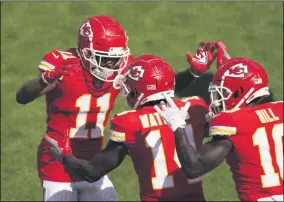  ?? CHARLIE RIEDEL - THE ASSOCIATED PRESS ?? Kansas City Chiefs wide receiver Sammy Watkins, center, celebrates with teammates Demarcus Robinson, left, and Tyreek Hill, right, after catching an 8-yard touchdown pass during the first half of an NFL football game against the Las Vegas Raiders, Sunday, Oct. 11, 2020, in Kansas City.