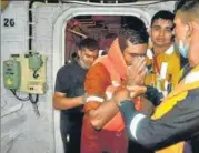  ??  ?? Naval personnel on board INS Kochi help a man rescued from the offshore Barge P305 in the Arabian sea on Wednesday.